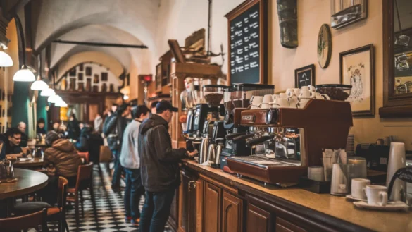 Traditional Italian coffee bar with patrons at a long counter, espresso machines, checkered floor, and warm, inviting lighting.